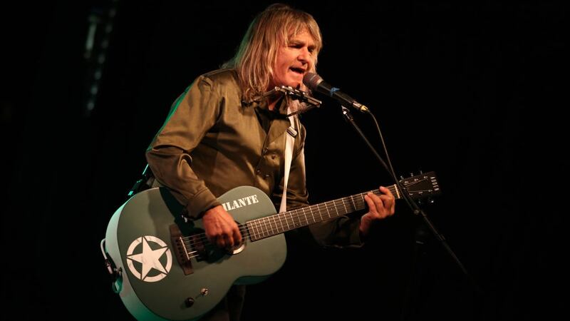 Mike Peters singing and playing guitar on stage