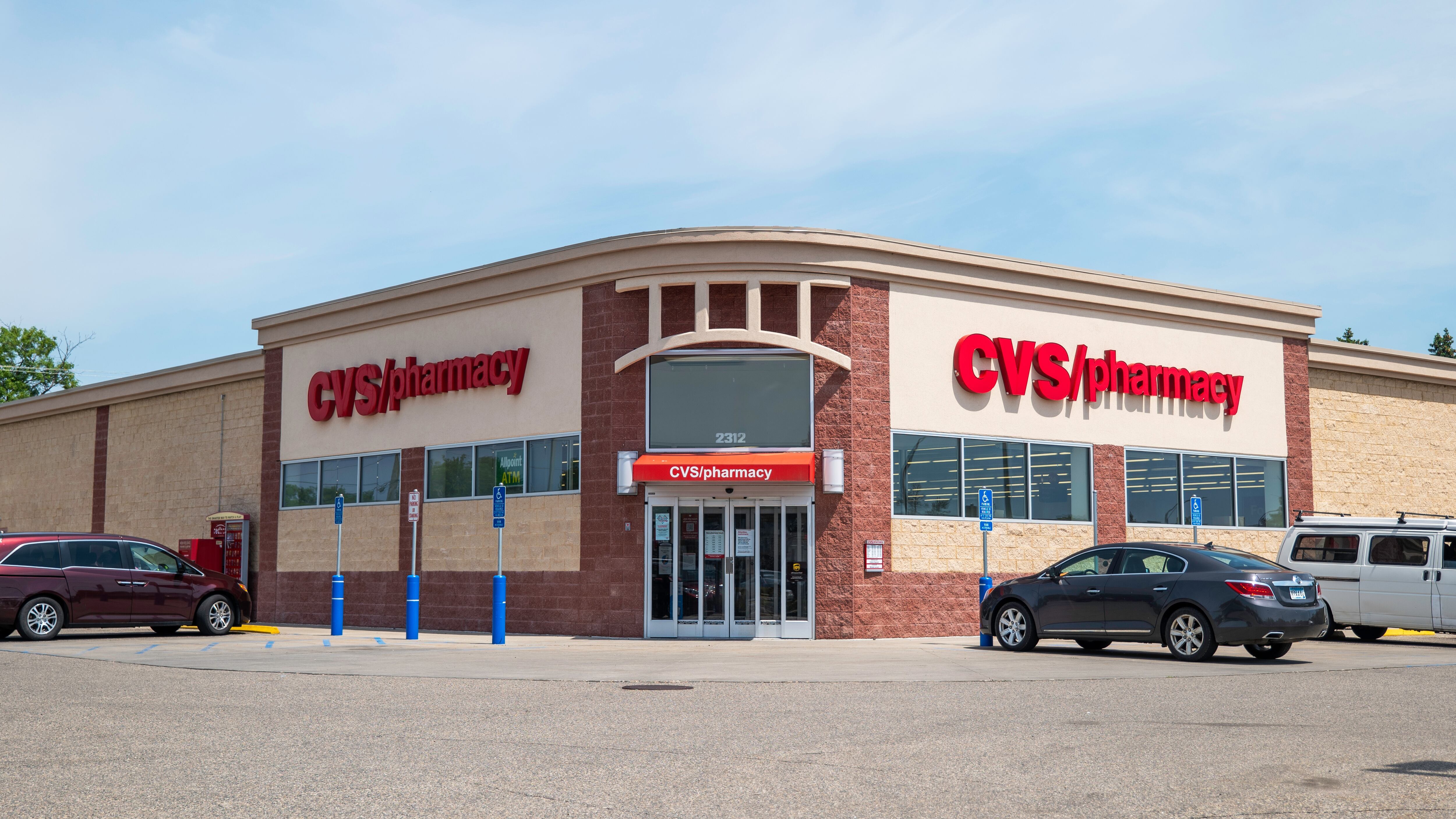 CVS Pharmacy building and parking lot with vehicles.